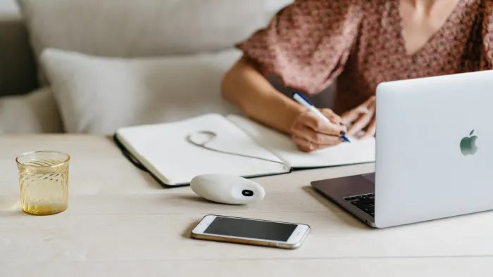 A woman writing with a moonbird on the table