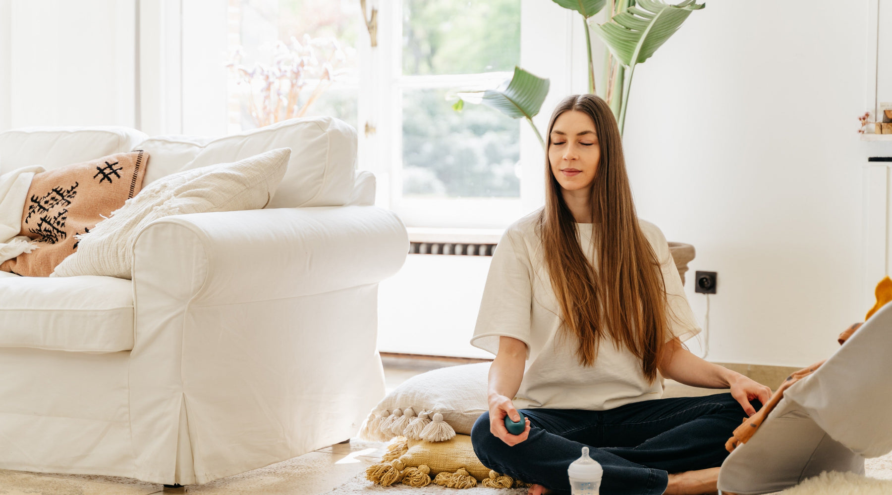 woman doing breathwork exercises in living room